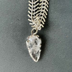 Topaz arrowhead pendant on silver plated fish plated fish bone necklace. 16”